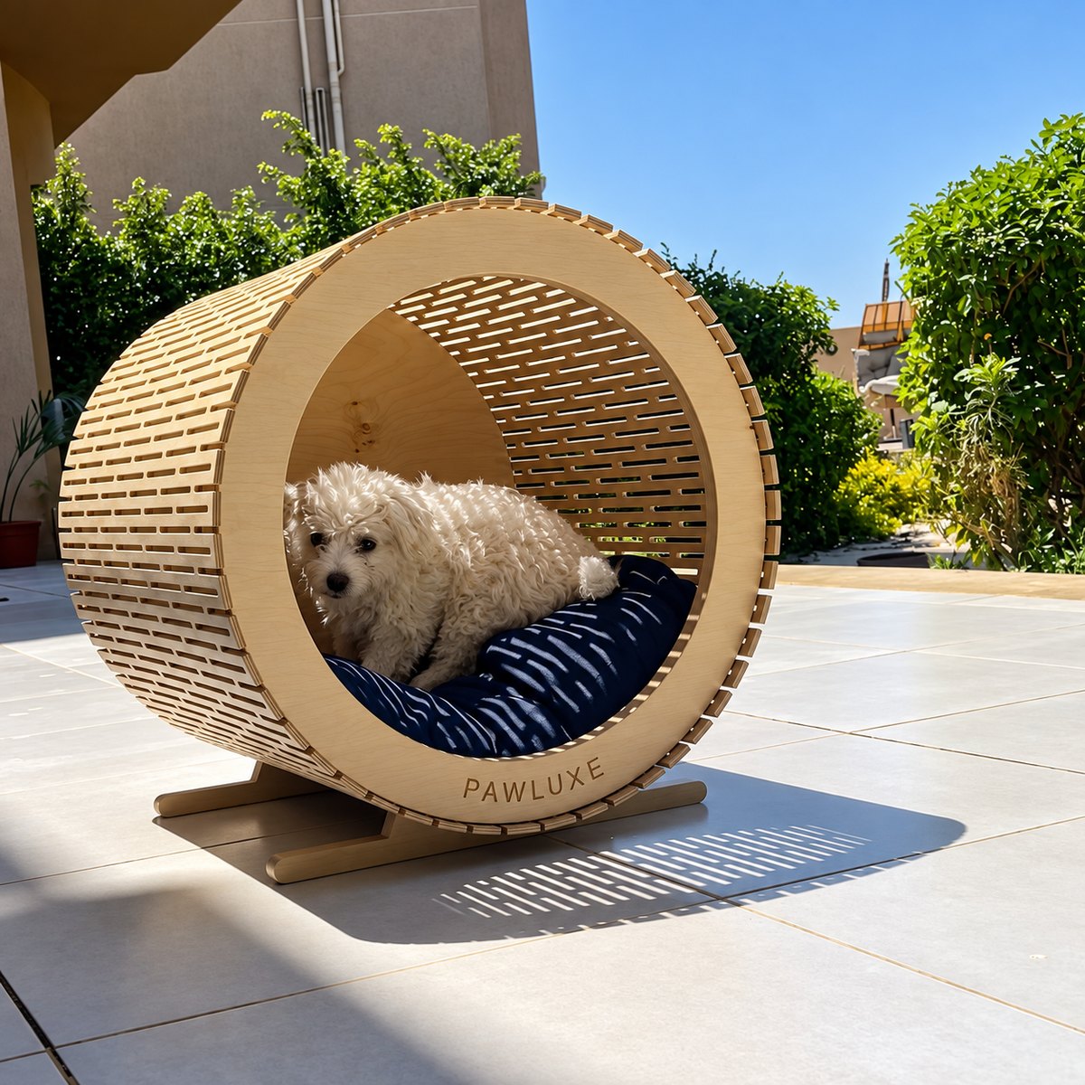 Fluffy resting inside GIGI on a sunny terrace, curled on the cushion in the curve of the drum.