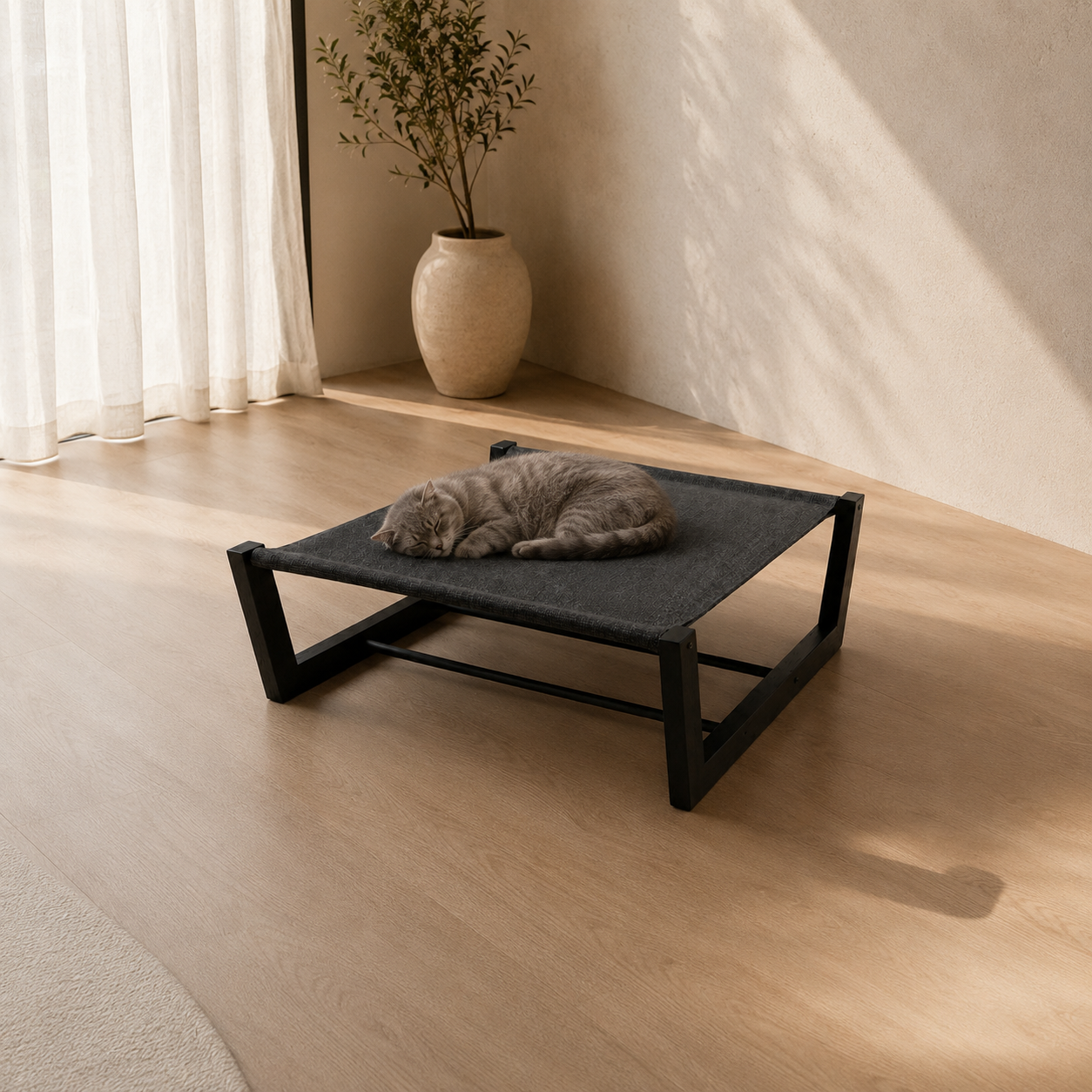 ONYX, a black-cushioned hanging cat bed off the floor, in a warm modern room.